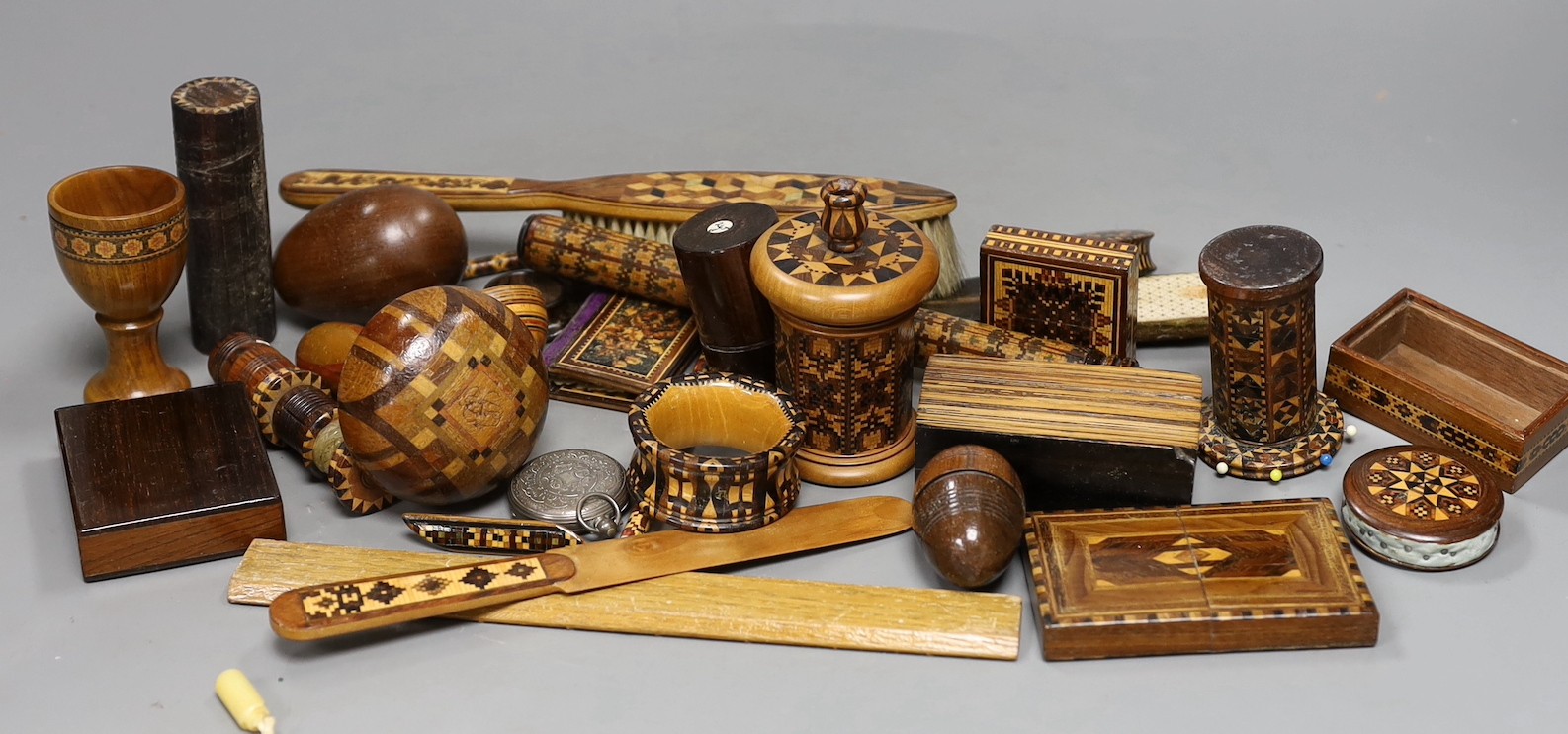 A selection of small Tunbridge ware sewing related items, boxes, letter opener, watch holder, napkin ring, unworked mosaic blocks and other related wood wares